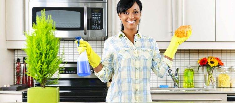 Young woman cleaning kitchen