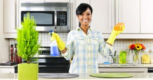 Young woman cleaning kitchen