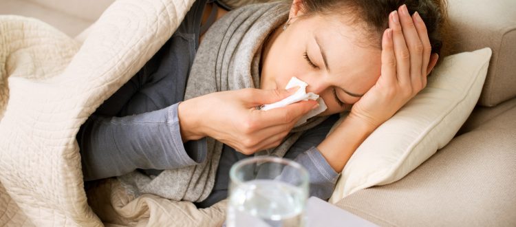 Sick Woman. Flu. Woman Caught Cold. Sneezing into Tissue